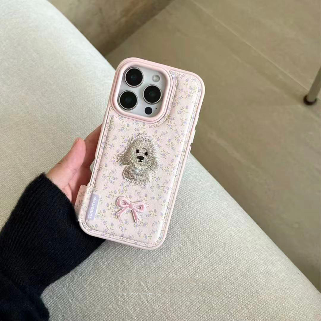 小狗蝴蝶结刺绣适用苹果16promax手机壳iPhone15卡通14promax可爱13日韩12创意16女款17promax大孔皮纹气囊11