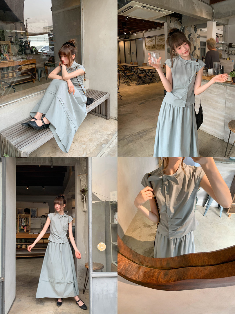 Light blue sleeveless maxi dress worn by a model in a cafe setting