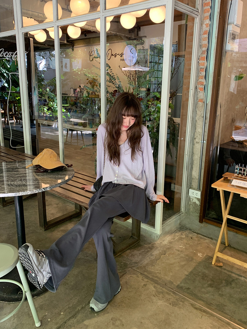 Woman wearing a light lavender blouse with dark wide-leg pants