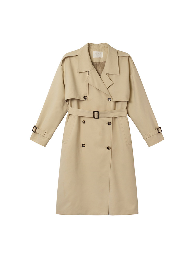 Beige trench coat with belt laid flat on a white background