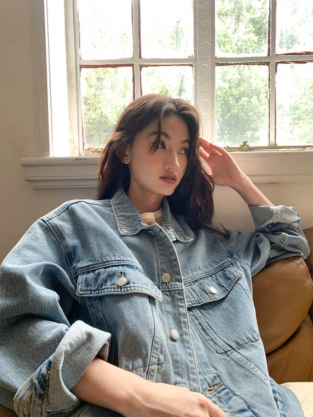 Woman wearing a light blue denim jacket indoors