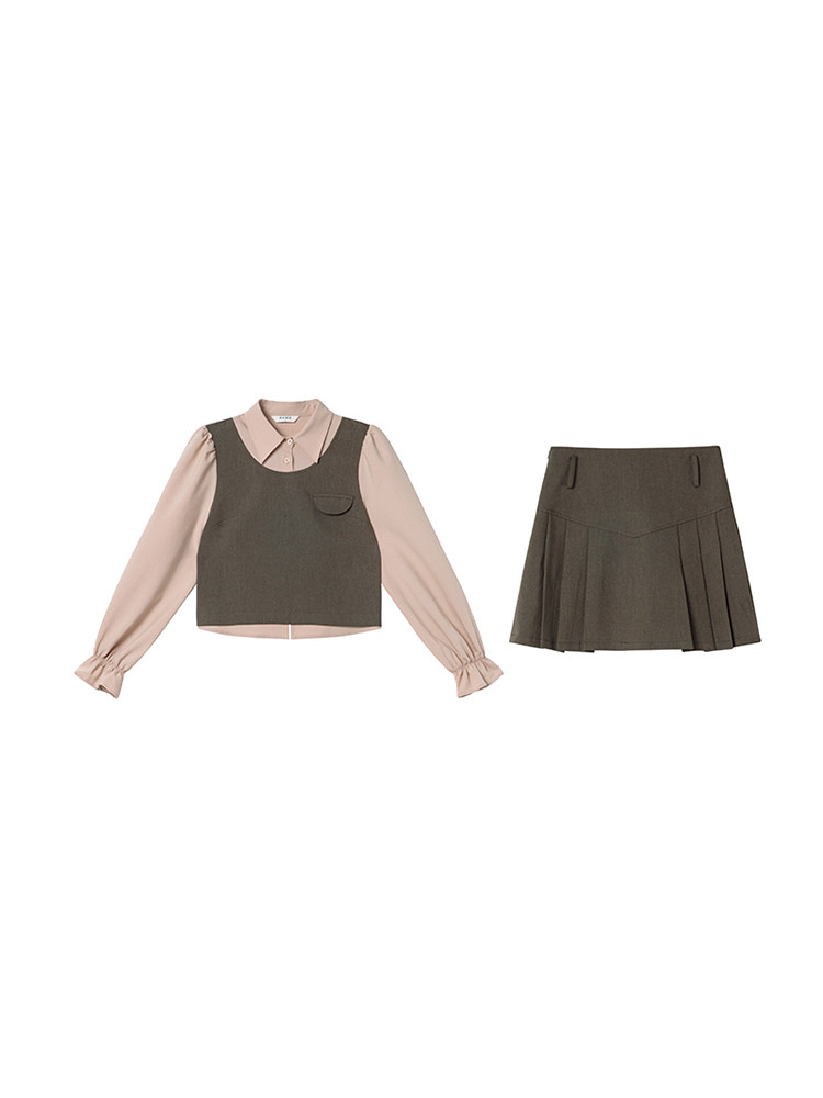 Two-piece outfit with a long-sleeve blouse layered under a sleeveless top and a pleated skirt on a white background