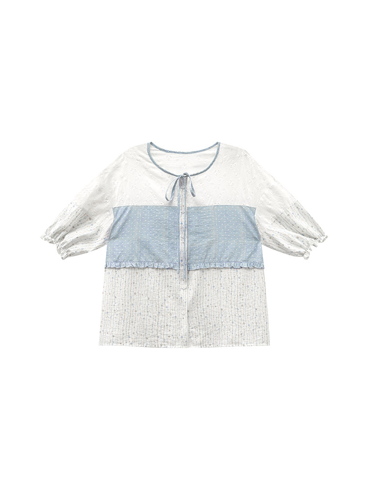 Light blue and white sheer short-sleeve blouse laid flat on a white background