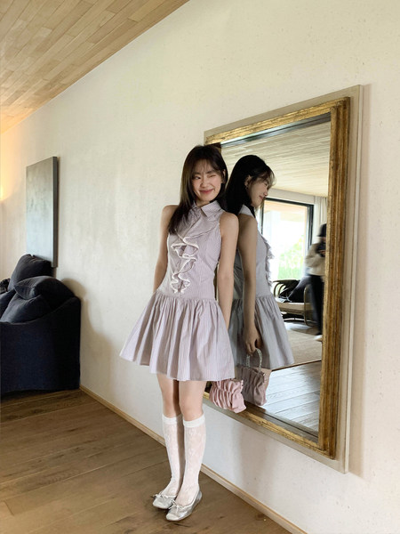 Model wearing a light pink striped ruffle mini dress