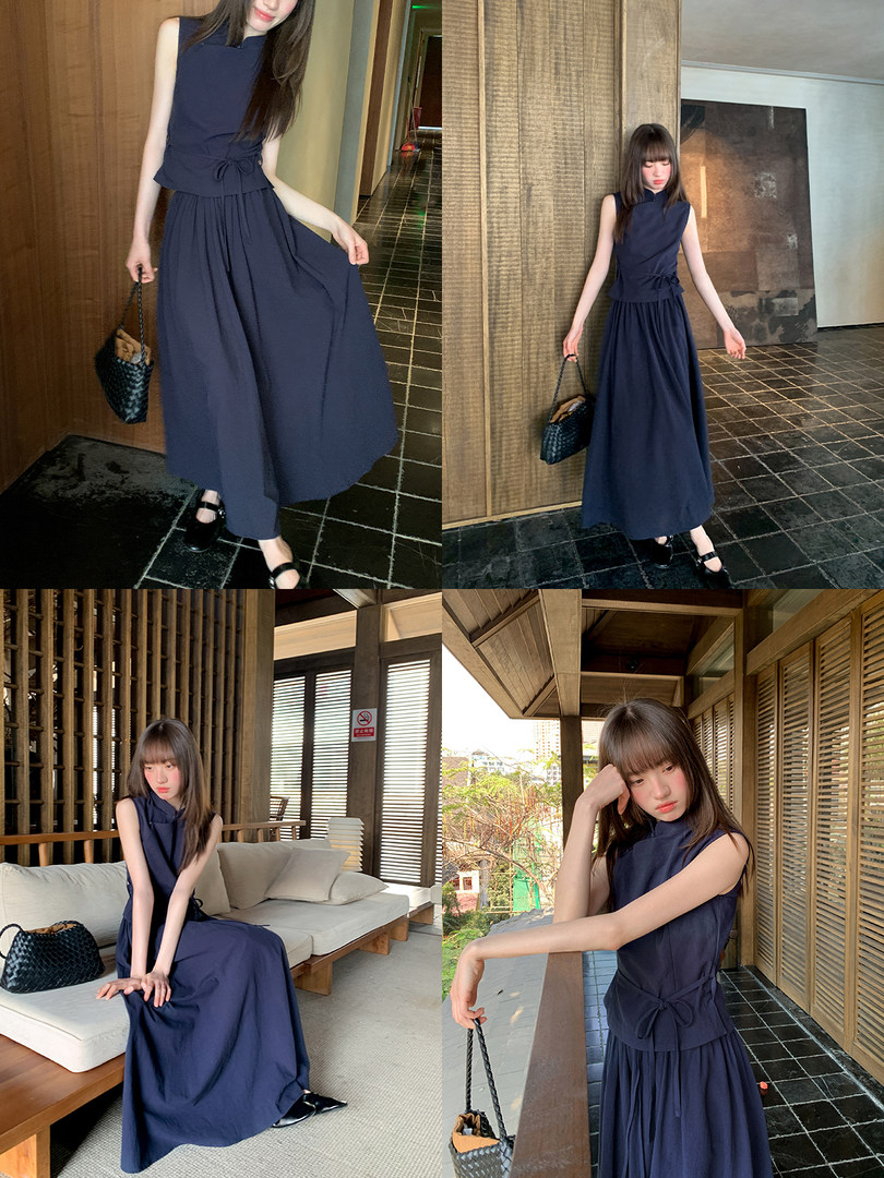 Navy sleeveless long dress worn by a model