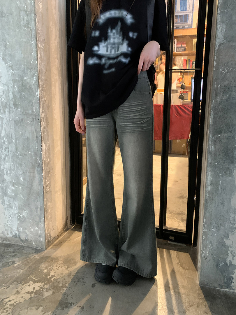 Model wearing gray wide-leg pants with a black top
