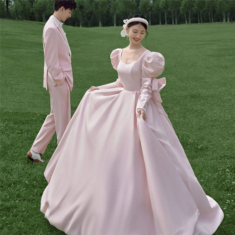 影楼情侣拍照服装粉色法式蝴蝶结缎面森系外景婚纱拖尾泡泡袖礼服