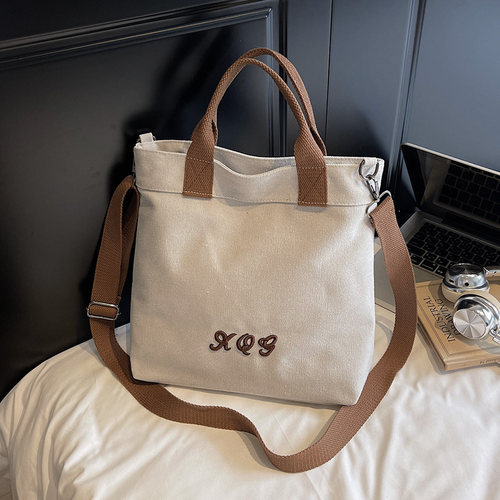时尚帆布包包女2025新款简约大容量竖款通勤托特包学生斜挎手提袋