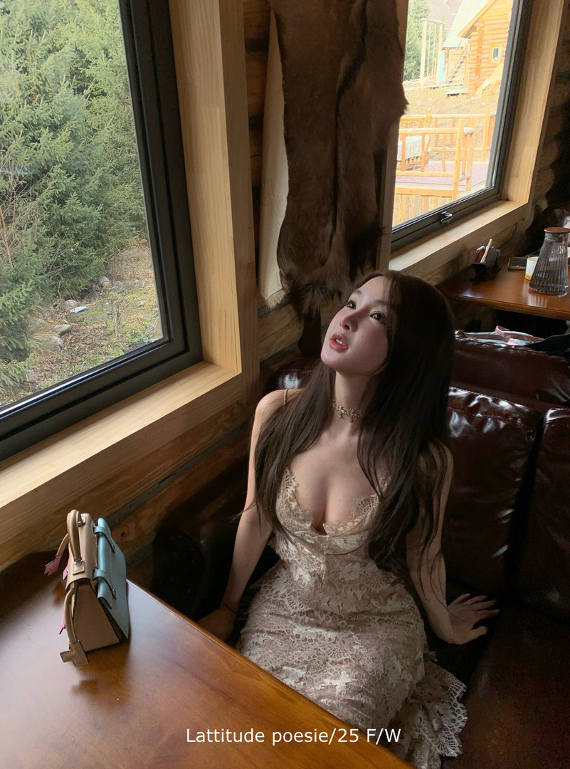 Woman wearing a cream lace dress indoors