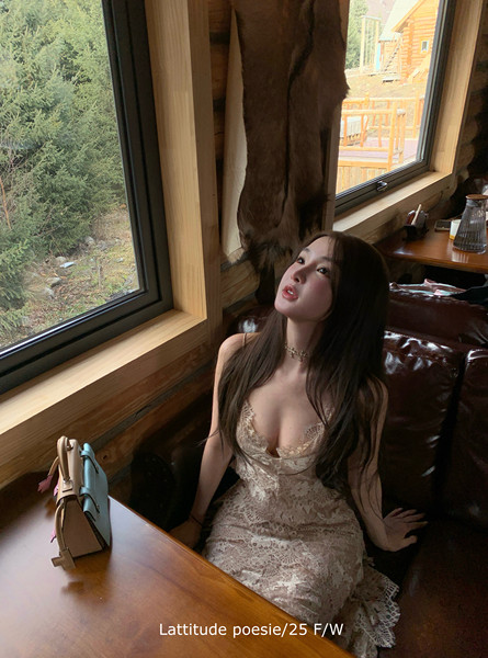 Woman wearing a cream lace dress indoors