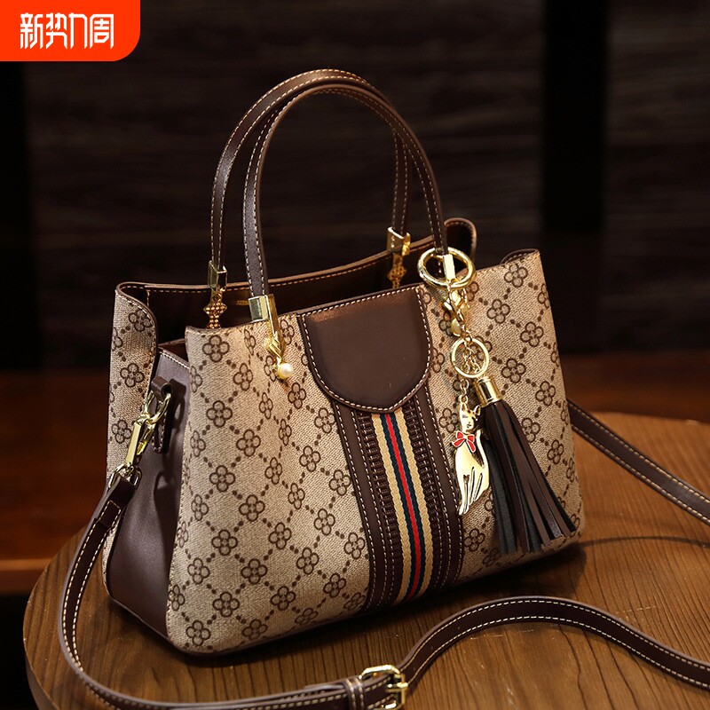 店酷奇真皮女包2026新款流行时尚百搭单肩斜挎包女士印花轻奢手提