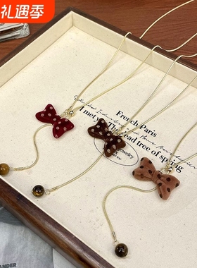 红色波点蝴蝶结抽拉项链秋冬小众设计可爱毛衣链超好看独特配饰