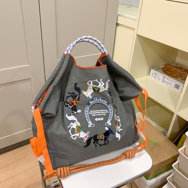 休闲刺绣通勤手提袋2025春夏新款时尚轻便大包女斜挎包敞口购物袋