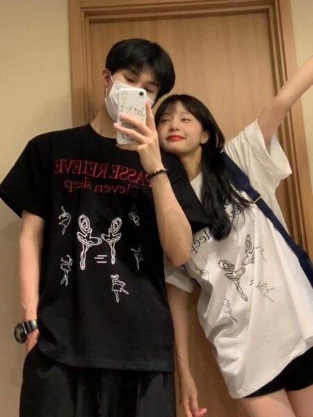 Couple wearing graphic oversized T-shirts in black and white