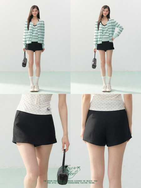 Model wearing a mint striped cardigan with black shorts and a white polka dot top