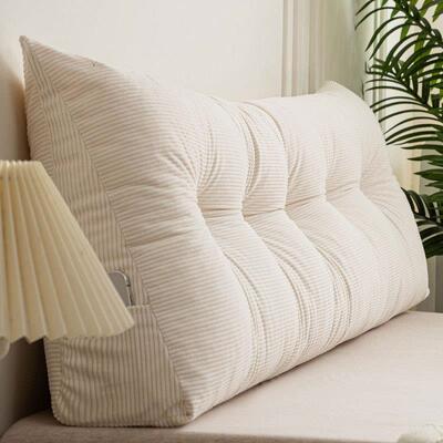 Triangular bed with big backs, pillows, and stubby living ro