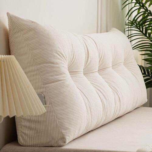 Triangular bed with big backs, pillows, and stubby living ro