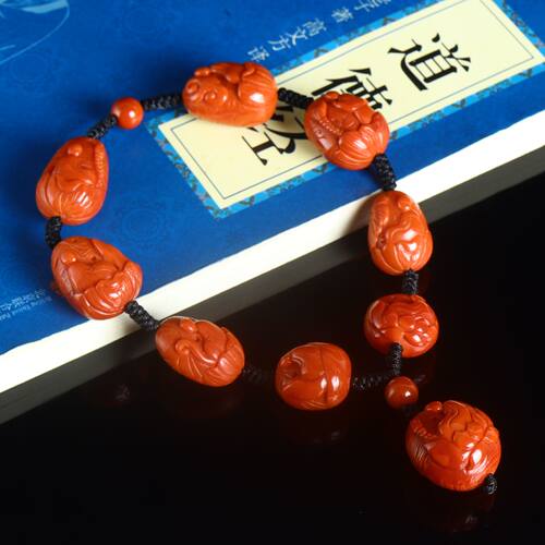 天然南红玛瑙手持柿子红雕刻悟道