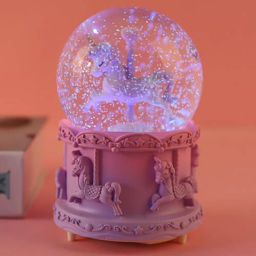 The carousel crystal ball music box glows and presents the c