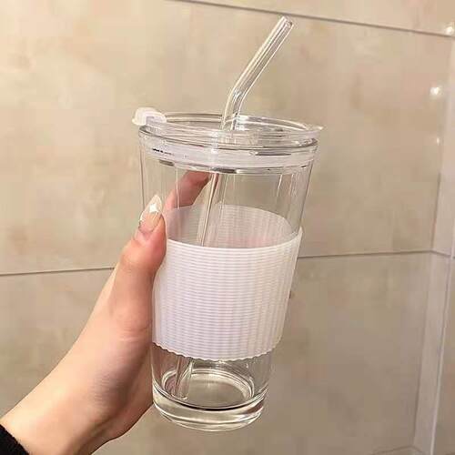 A glass with a cap on a straw glass and a cup of ins-valued