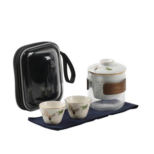 Two cups of ceramic tea cups outside of a portable tourist t