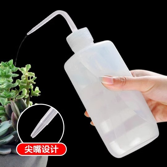 A handheld plastic transparent watering bottle with a long