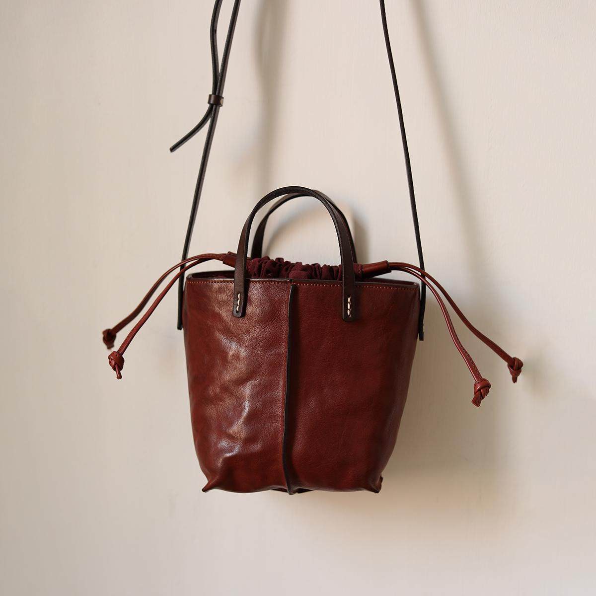 荣轻复古牛皮手提水桶包植鞣皮做旧抽带小众设计单肩女包斜挎包,箱包皮具/热销女包/男包,水桶包,淘宝优惠券,粉丝福利购,淘宝优惠卷