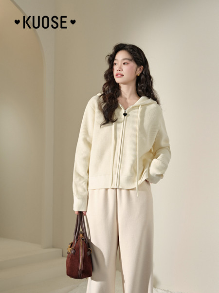 Cream knit hoodie and wide-leg pants worn by a model