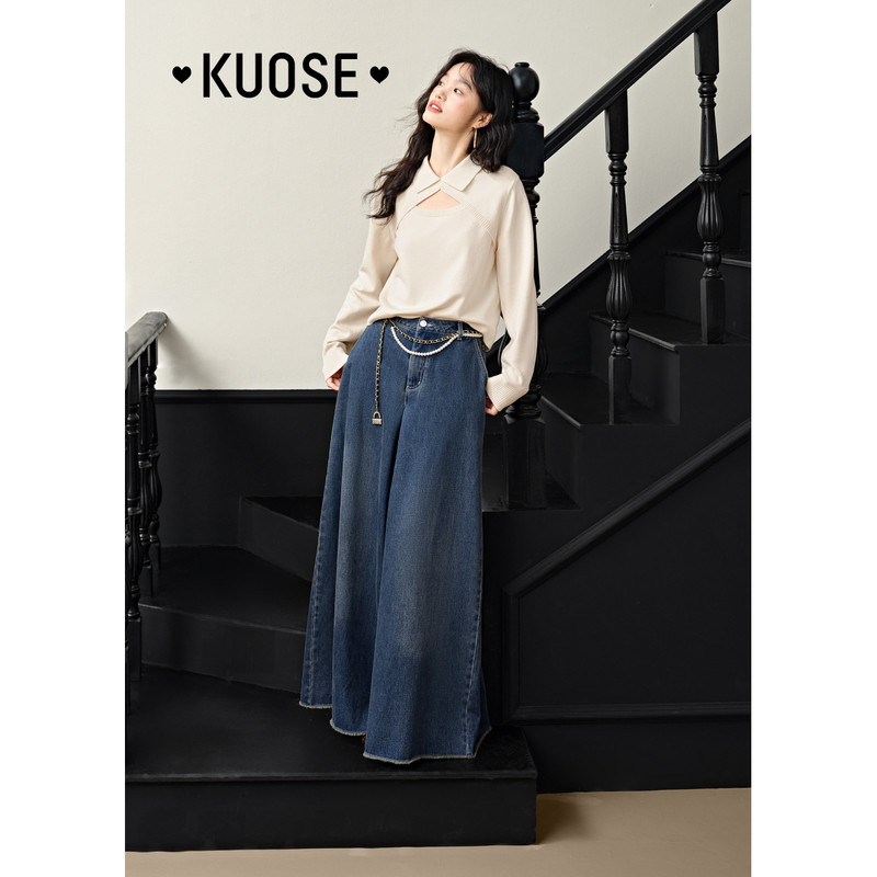 Model wearing a cream blouse and a long blue denim skirt