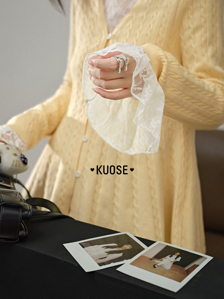Woman wearing a light yellow lace-trim dress with long sleeves