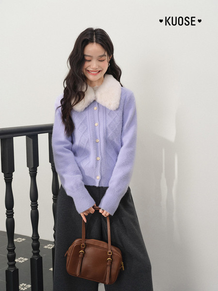 Lavender fuzzy-collar cardigan worn by a smiling model with a brown handbag