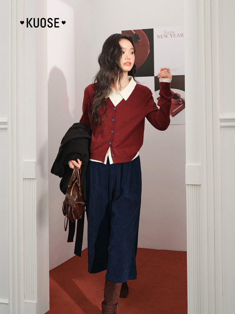 Model wearing a burgundy cardigan with a white collar and navy wide-leg pants