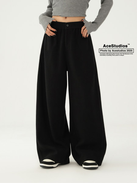 Model wearing black wide-leg pants with a gray cropped sweater