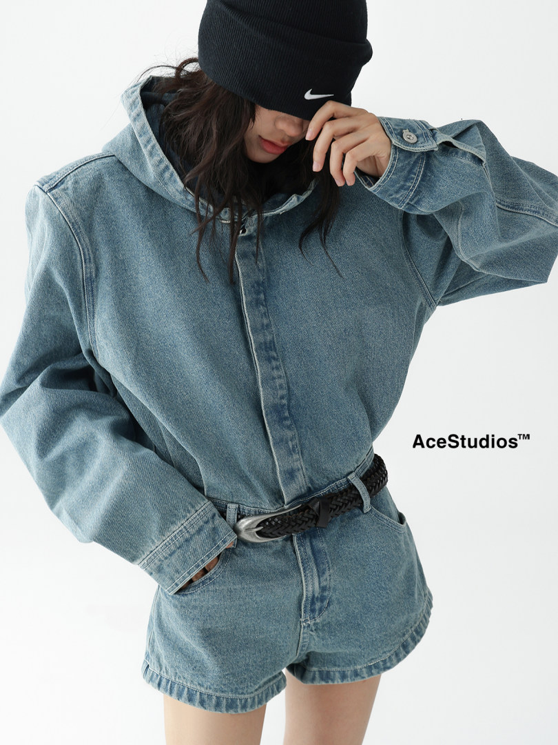 Woman wearing an oversized denim hoodie and denim shorts on a white background