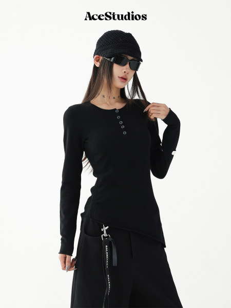 Black long-sleeve fitted top and wide-leg pants worn by a model with accessories