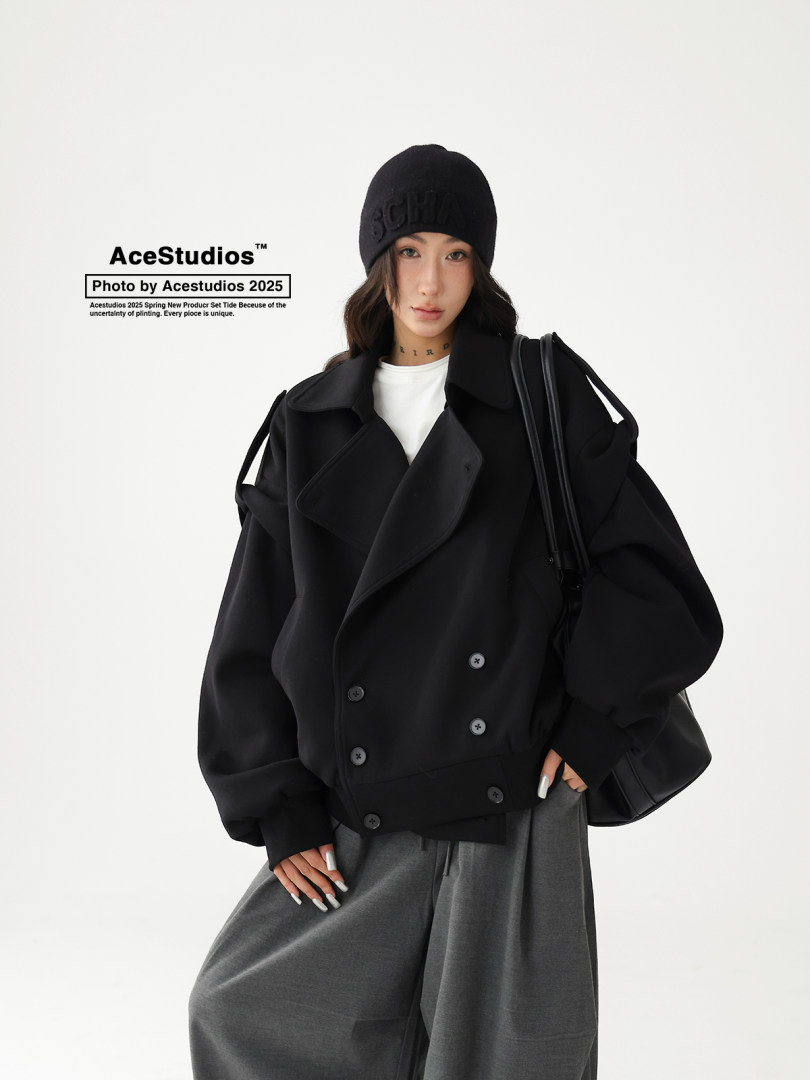 Model wearing a black oversized jacket with beanie and bag