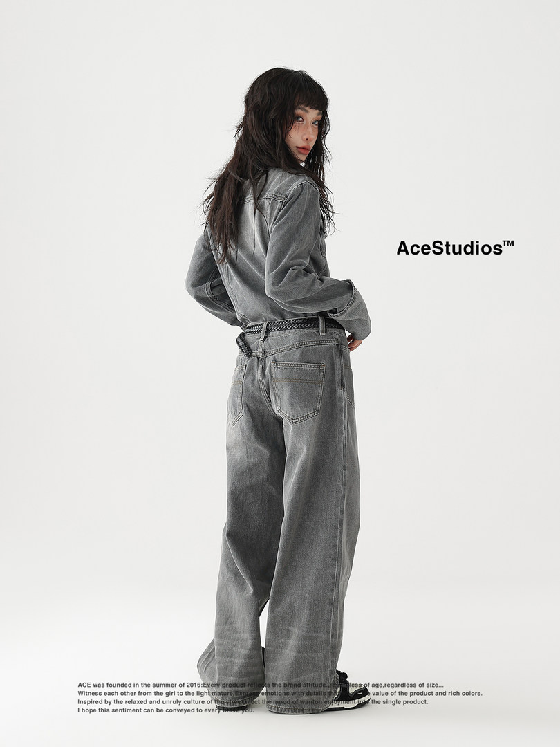 Model wearing oversized gray denim outfit on a white background