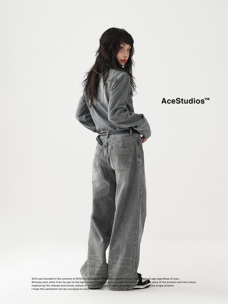 Model wearing oversized gray denim outfit on a white background