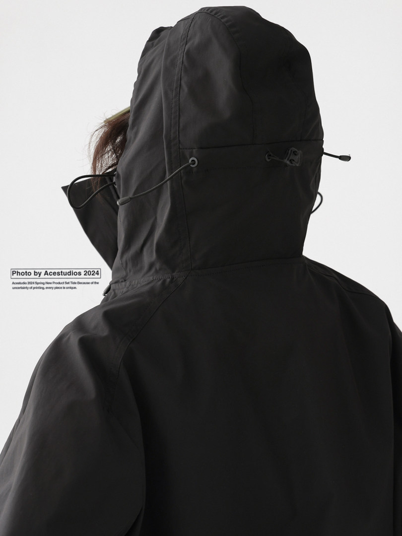 Black hooded jacket worn by a model from the back
