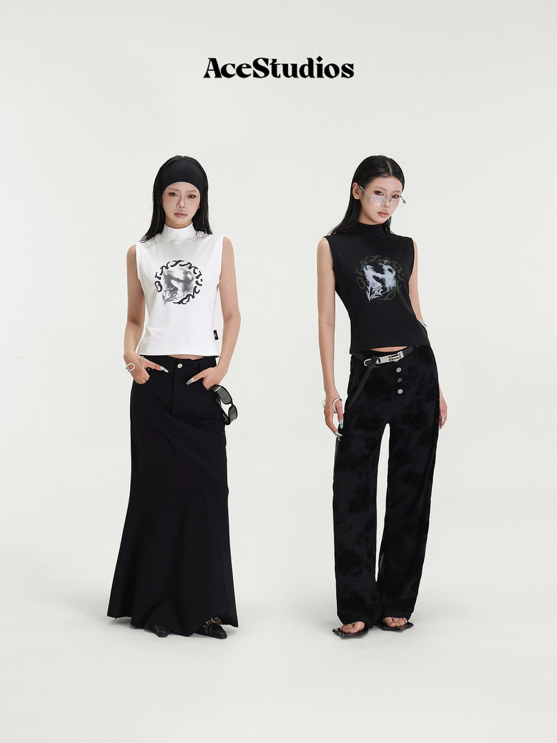 Two models wearing black and white sleeveless graphic tops with black bottoms on a plain studio background