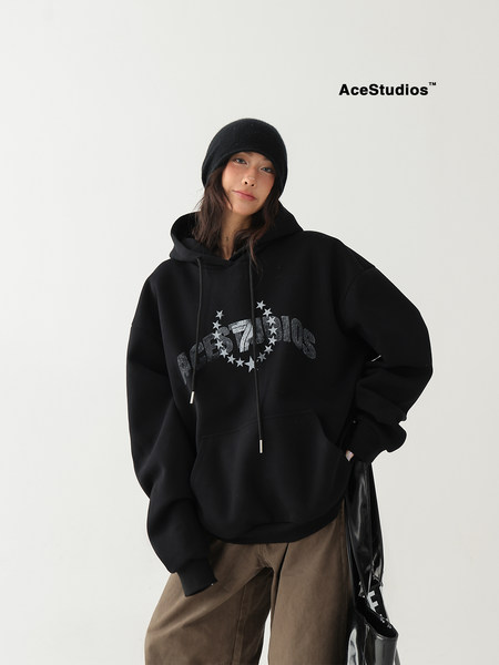 Model wearing a black oversized graphic hoodie and beanie