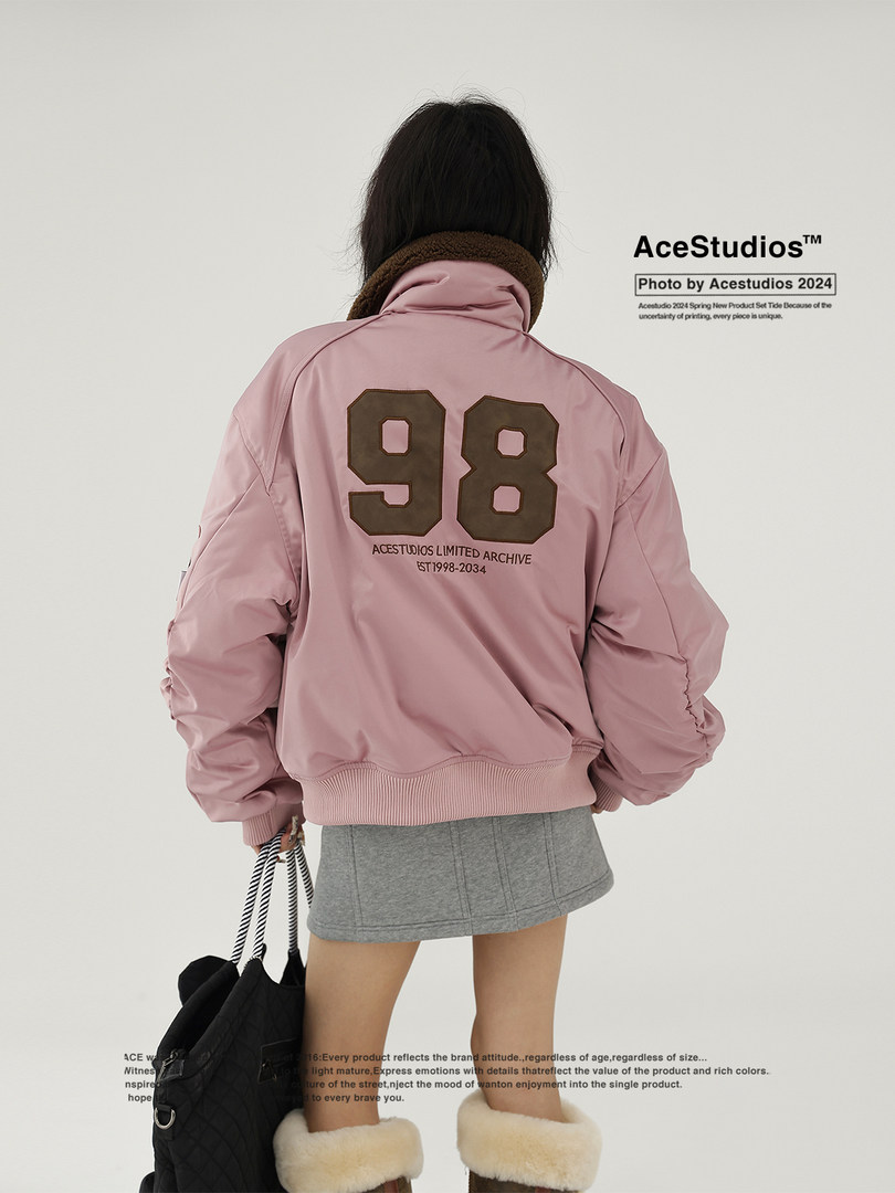 Pink bomber jacket worn by a model with a large back number graphic