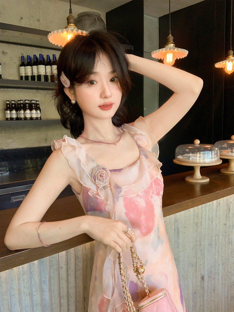 Woman wearing a pastel floral ruffled dress in a restaurant