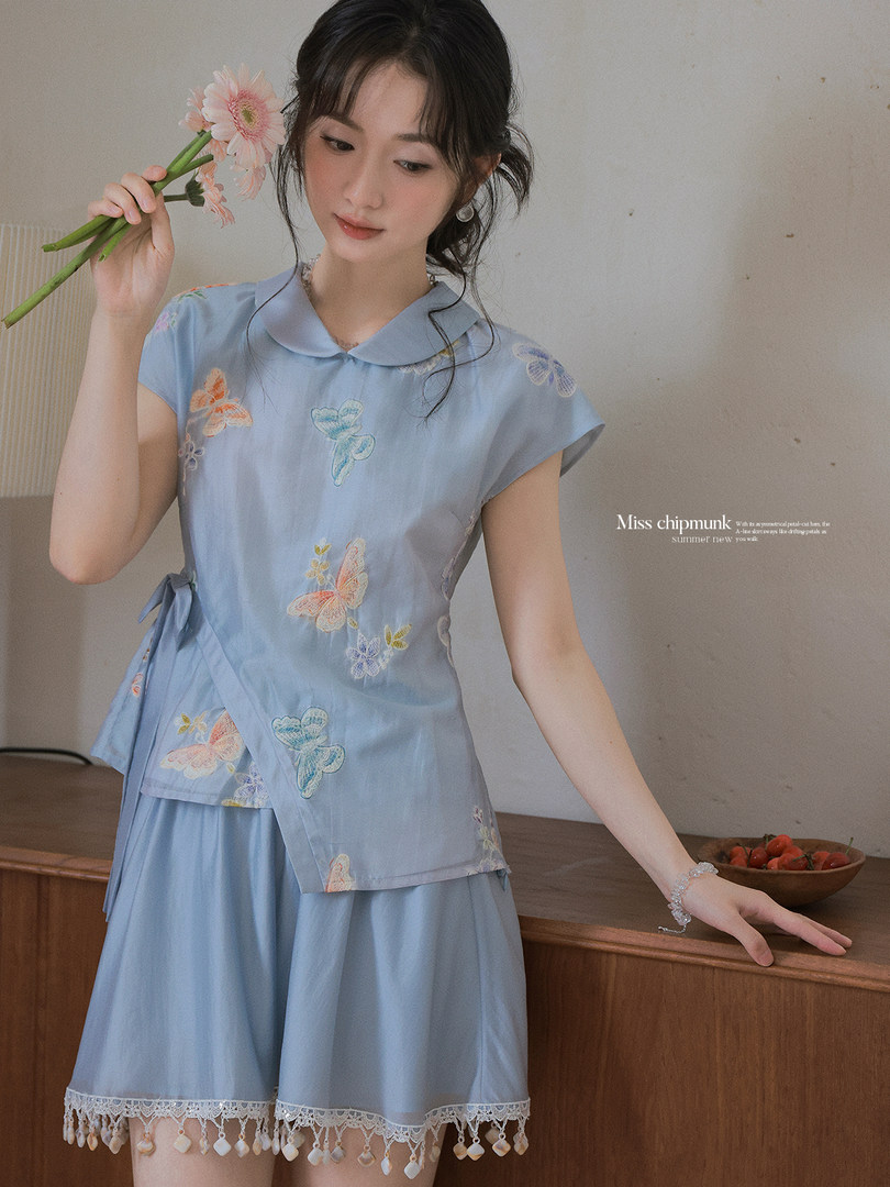 Light blue floral butterfly two-piece outfit worn by a model