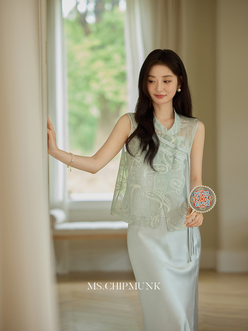 Woman modeling a light blue sleeveless dress outfit