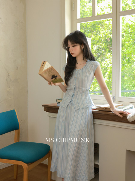 Light blue striped sleeveless top and matching skirt worn by a model