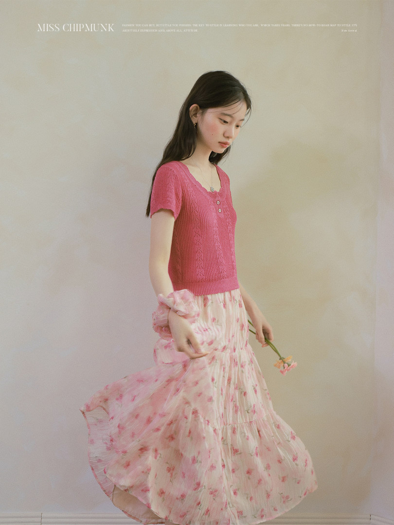 Woman wearing a pink knit top and floral skirt