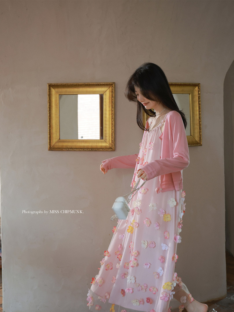Pink floral appliqué dress with matching cardigan worn by model