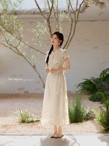 Cream lace midi dress worn by a model outdoors
