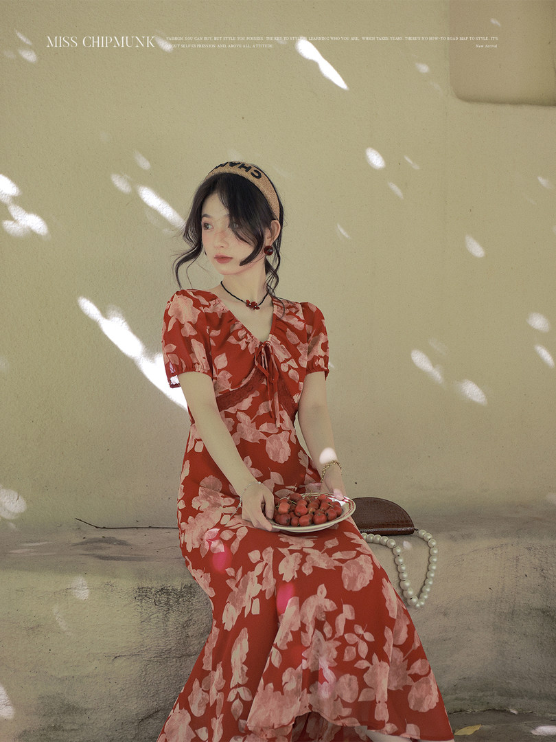 Model wearing a red floral maxi dress with short puff sleeves